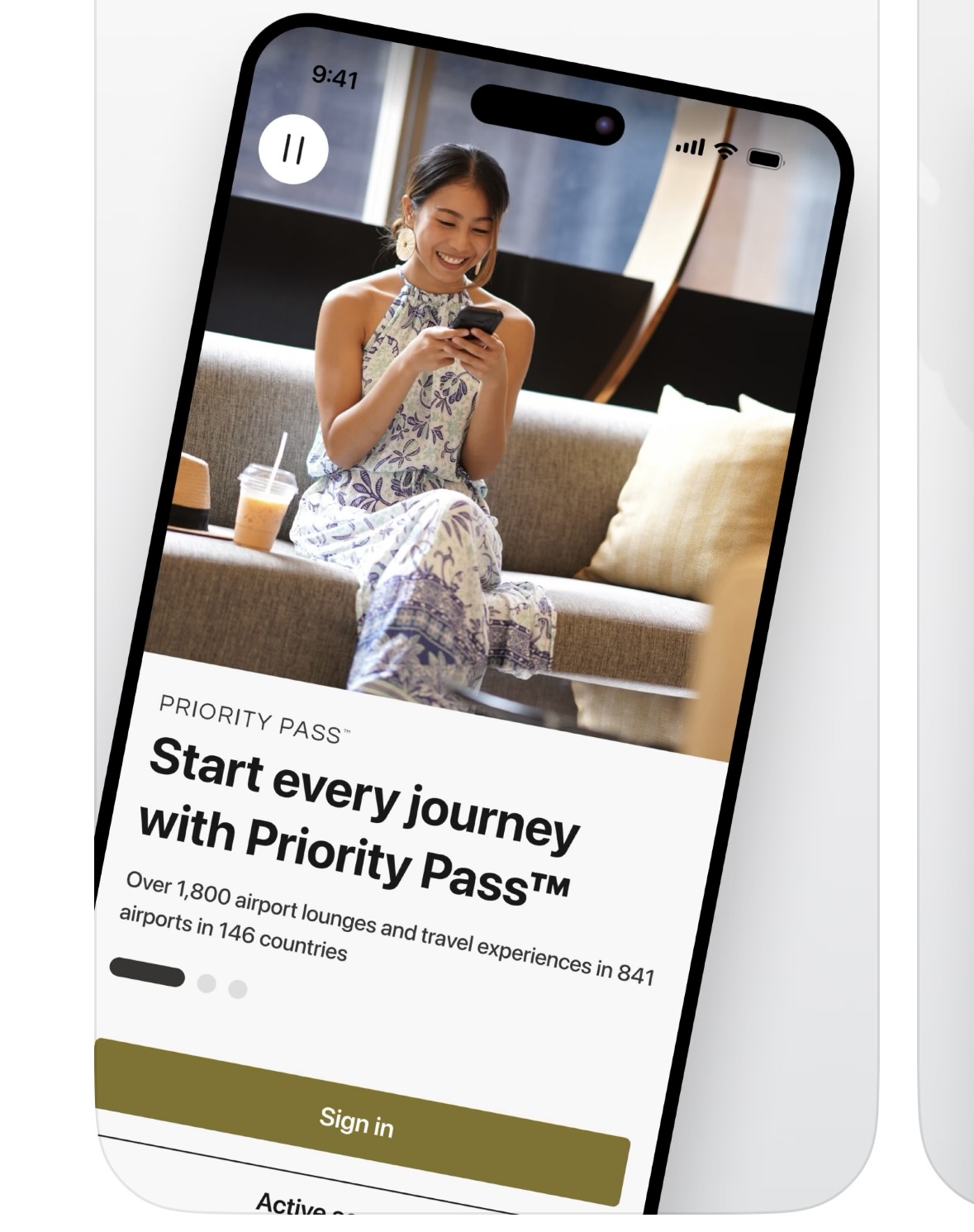 a woman sitting on a couch looking at her phone