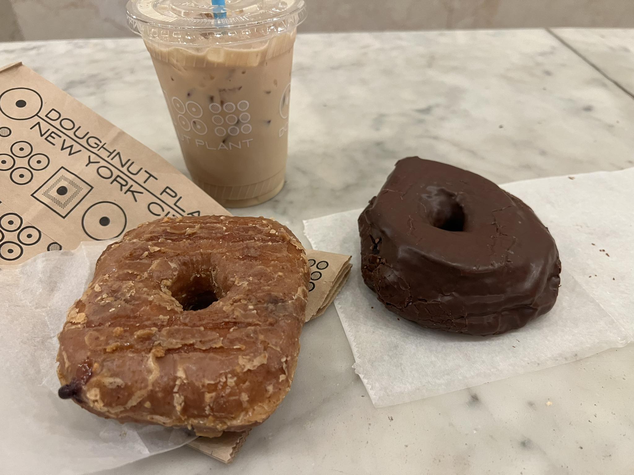 a chocolate donuts and a drink on a table