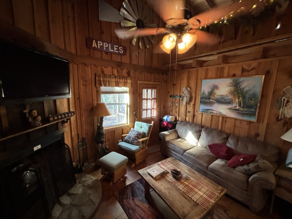 a living room with a fan and a couch