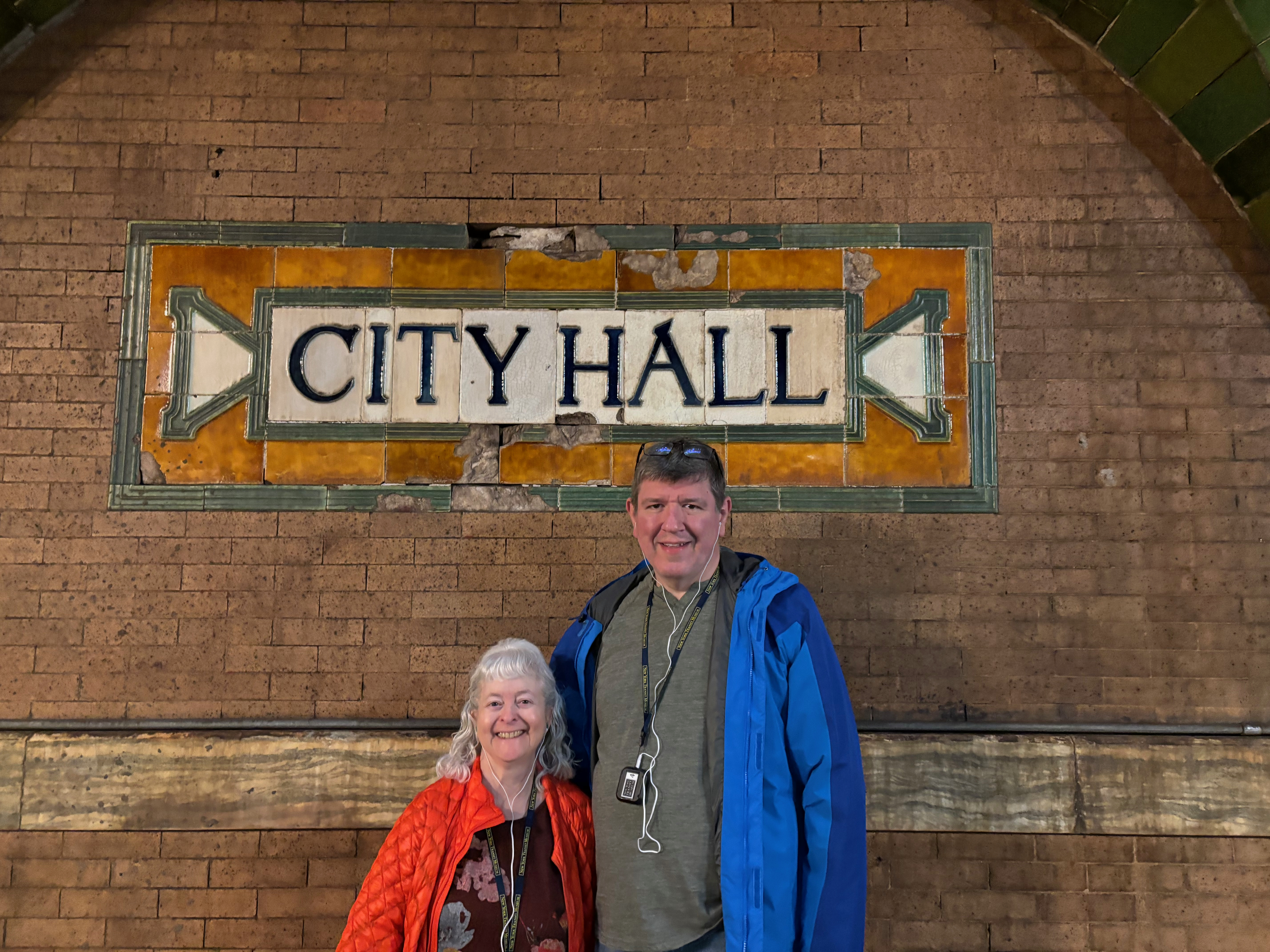 a man and woman standing in front of a sign