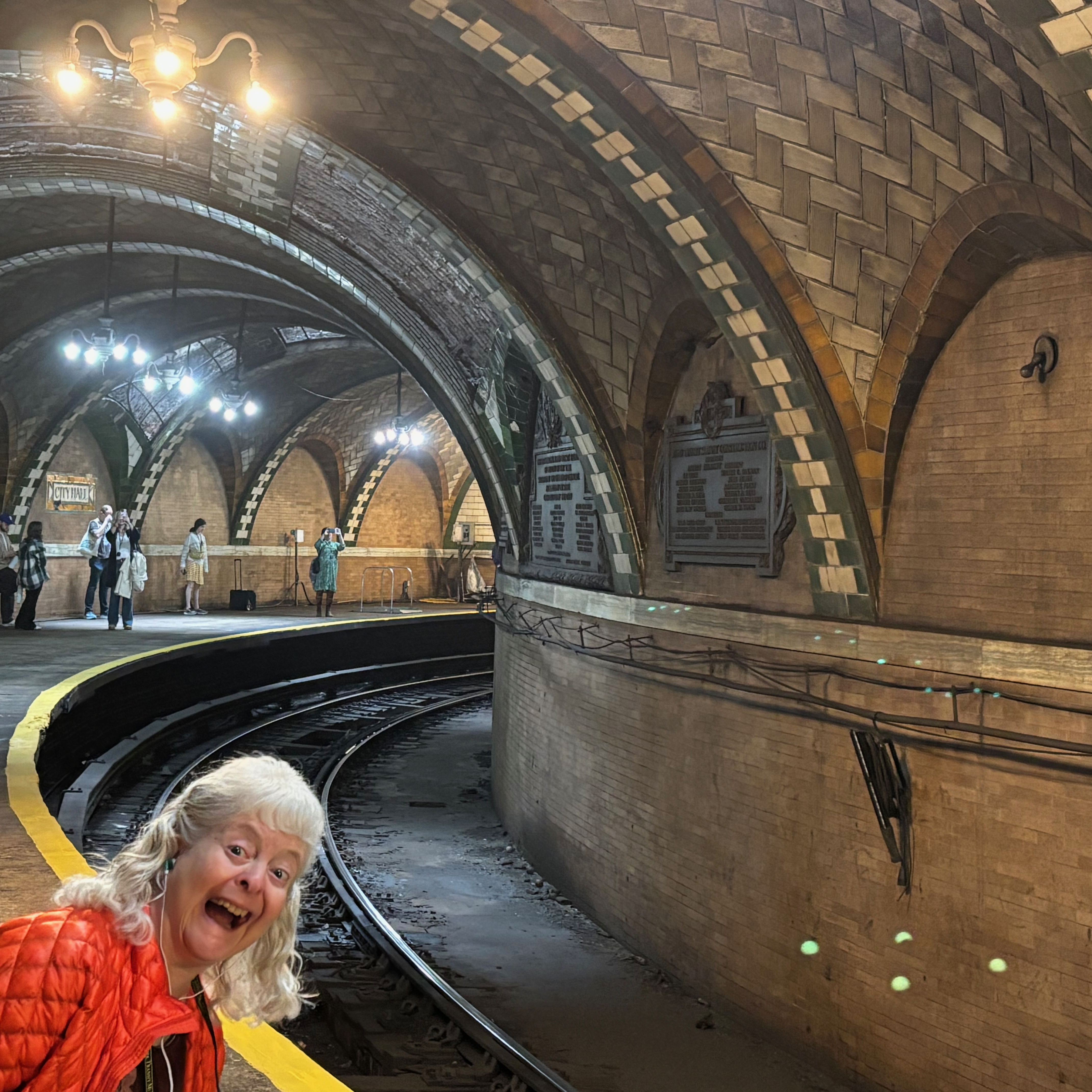 a woman in a tunnel with train tracks