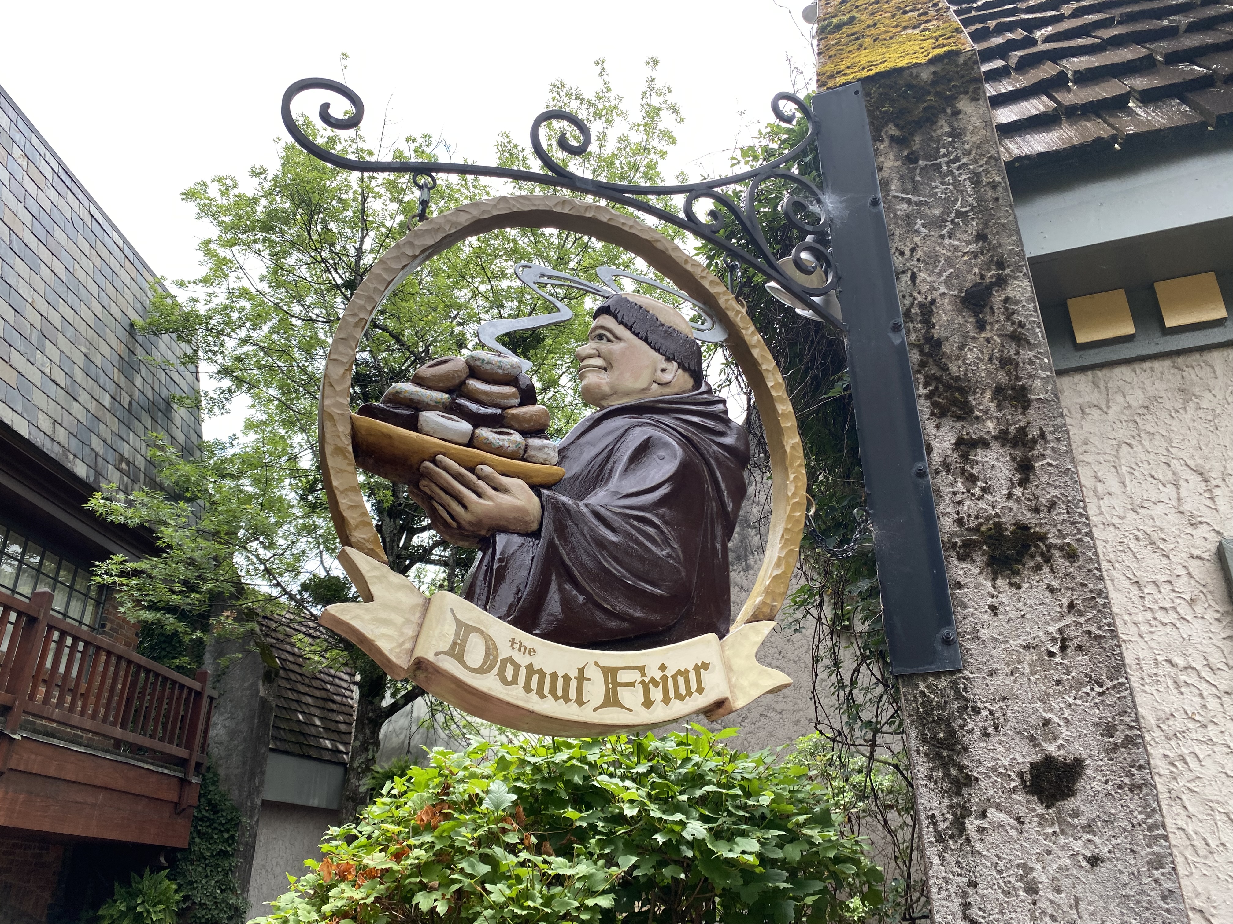 a sign with a person holding a tray of food