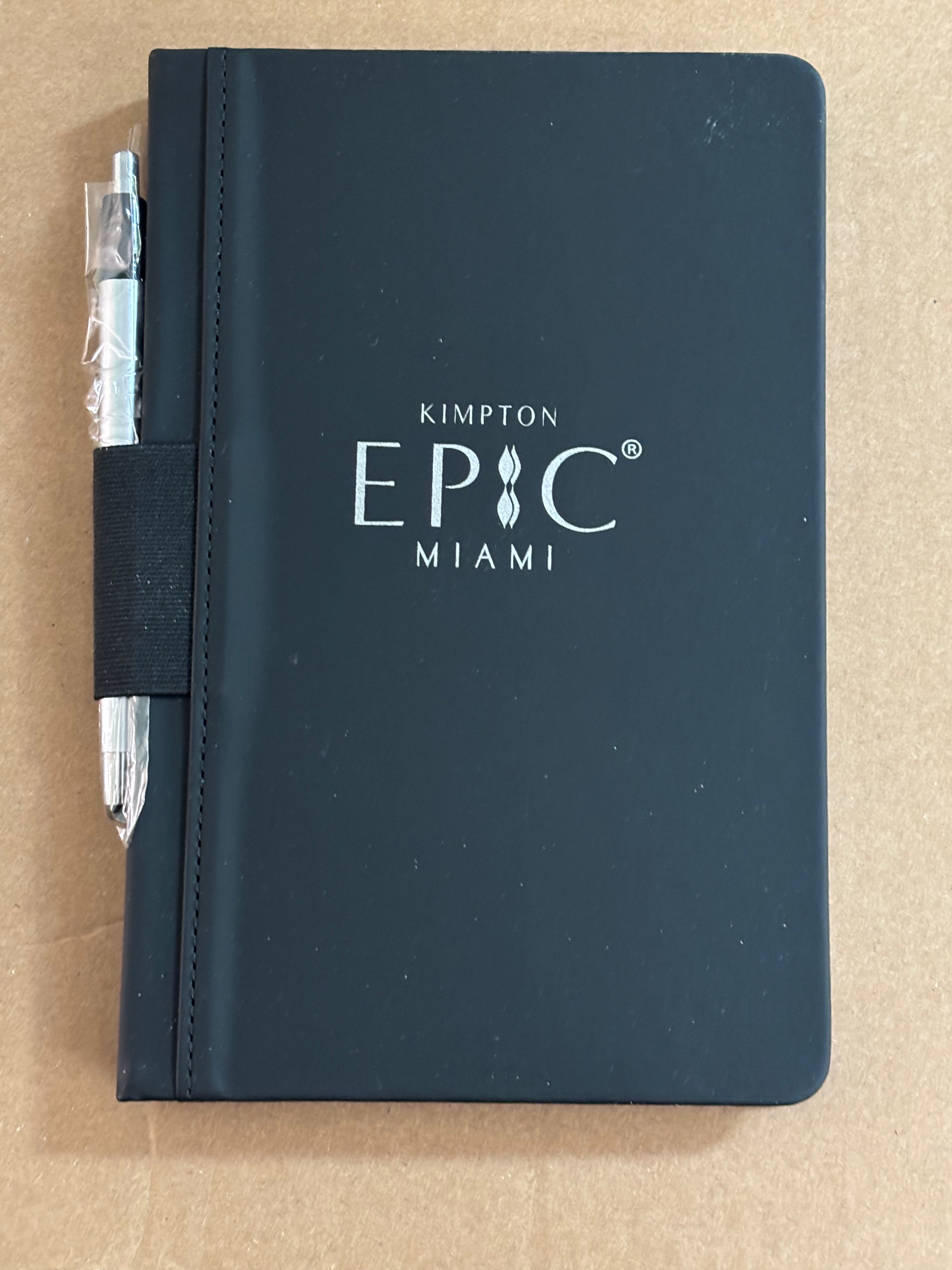 a black notebook with a pen