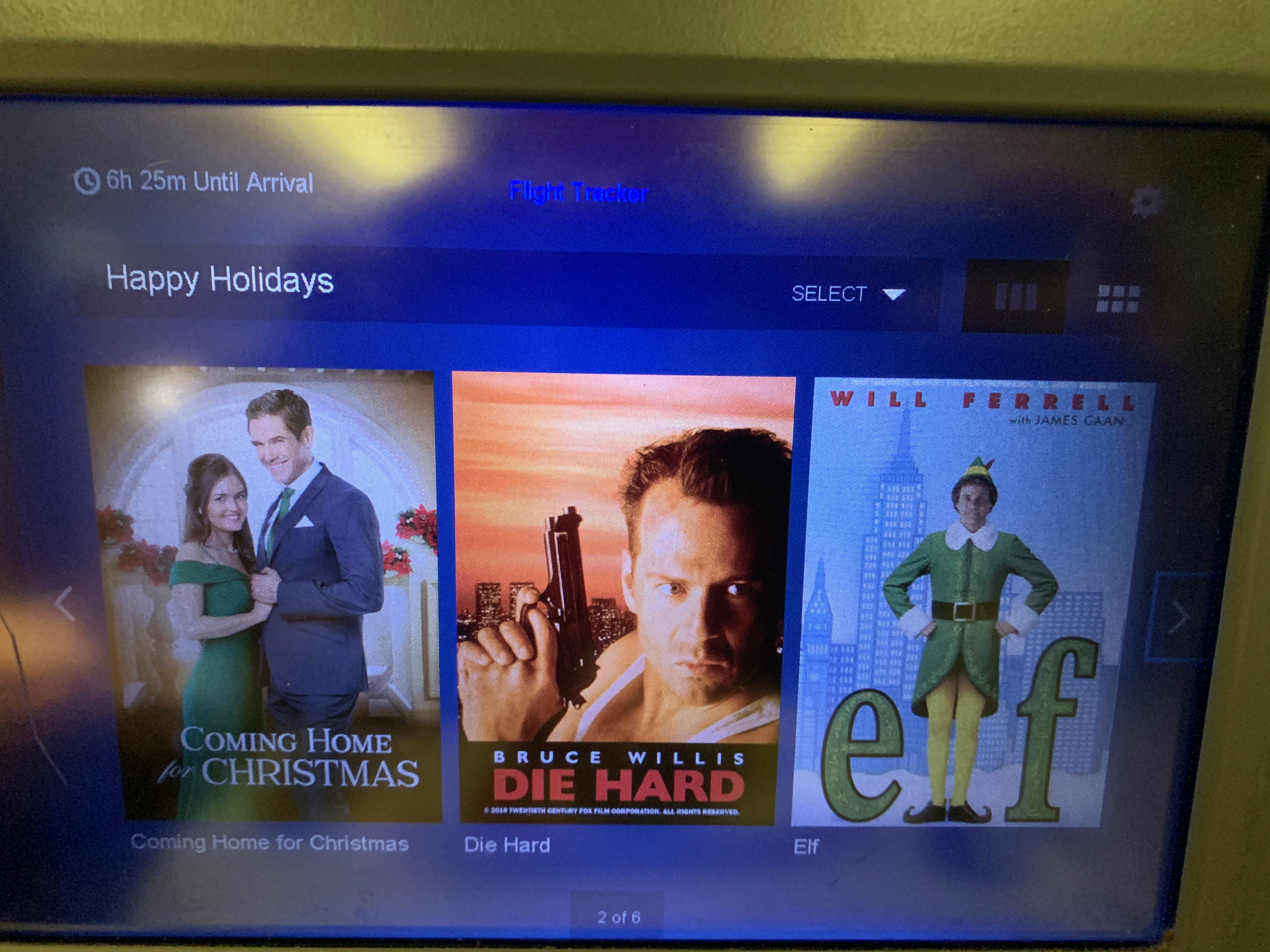 Delta in-flight entertainment screen showing Die Hard listed under Holiday films
