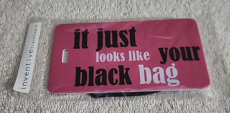 a pink tag with black text on it