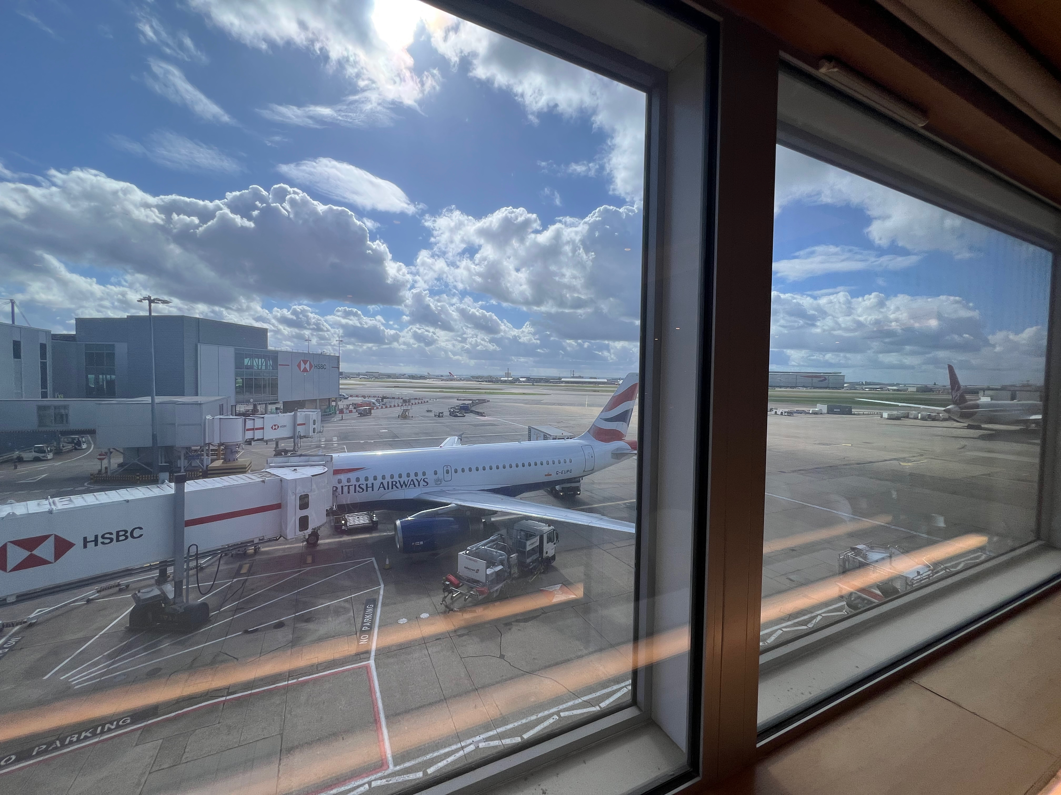 View through the lounge window with an aircraft parked outside at Heathrow