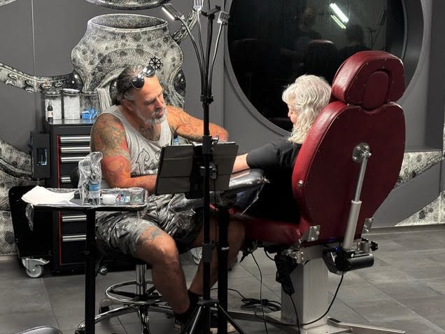 a man and woman sitting in a chair