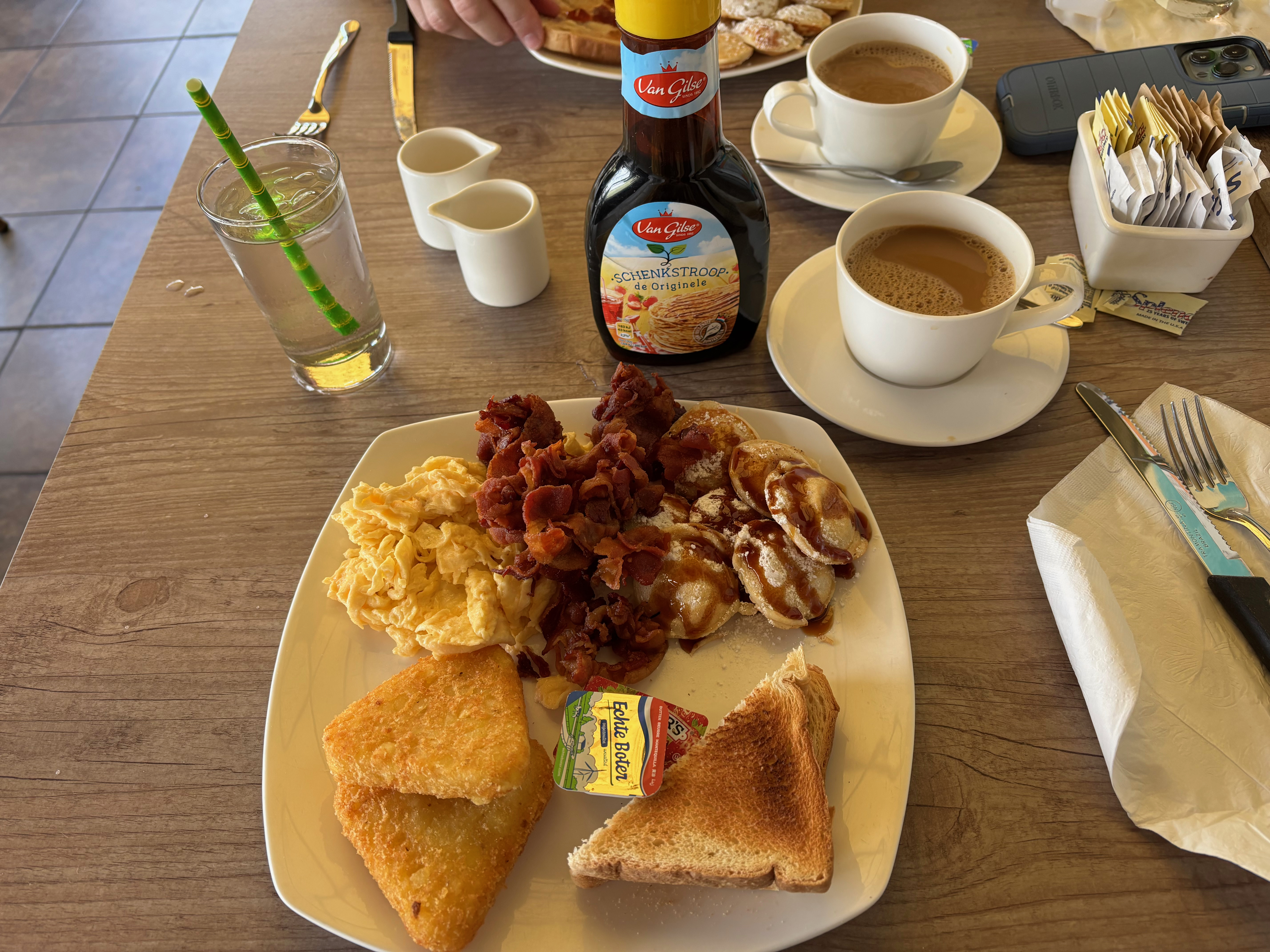 a plate of food and cups of coffee on a table