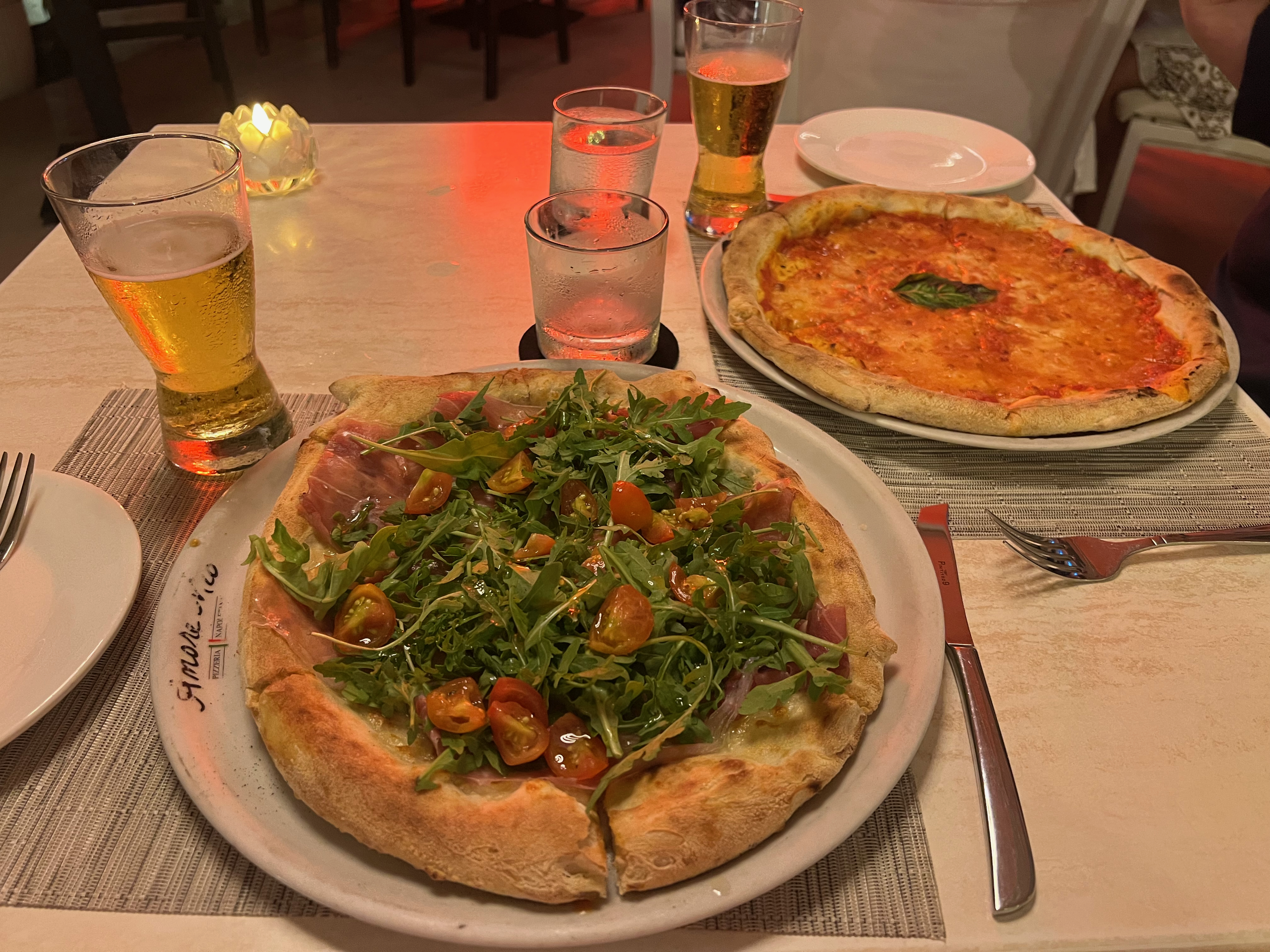 a pizza and a drink on a table