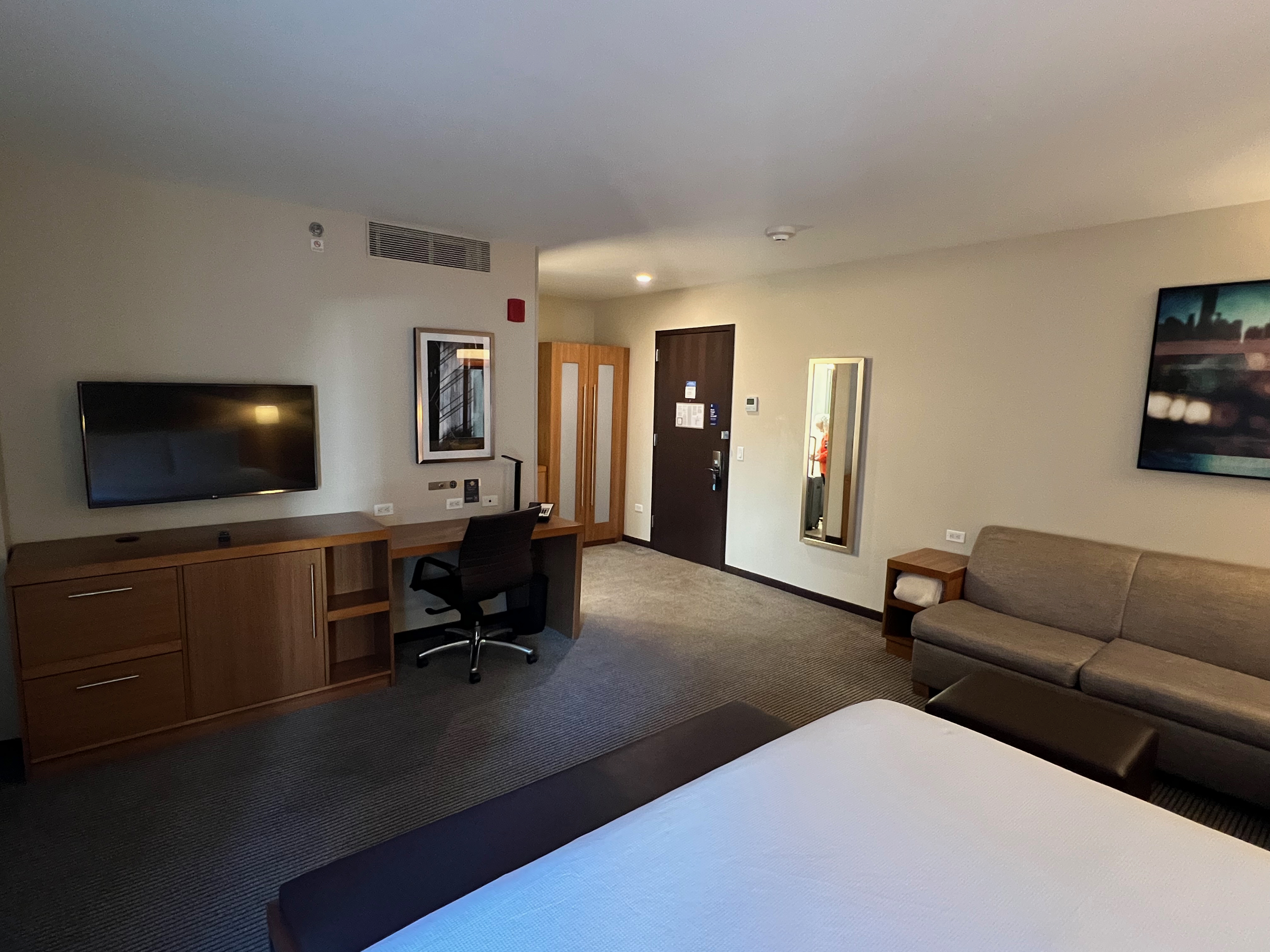 a room with a bed and a television